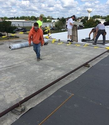 Get a free quote on a new or replacement roof Commercial flat roof installers at work in Wisconsin