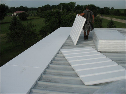 Our industrial roofing crews get your installation or repair done right the first time Fredonia WI commercial roofing contractors installing a TPO roofing system
