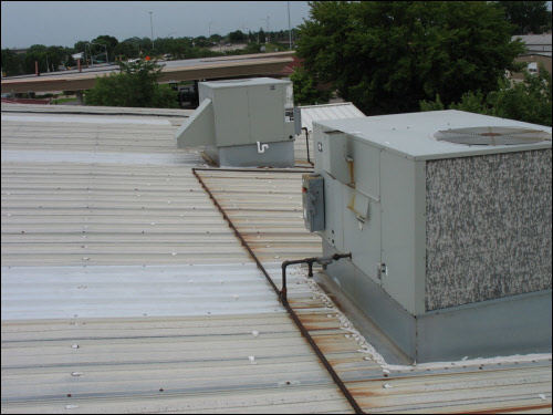 Industrial metal roofing BEFORE our TPO install Industrial metal flat roof in Waunakee Wisonsin before TPO membrane retrofit