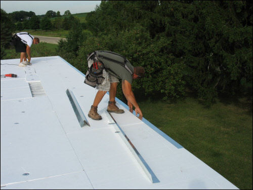 Termination Bar Installation in Wisconsin Installing a roof termination bar on a new industrial flat roof in Wisconsin